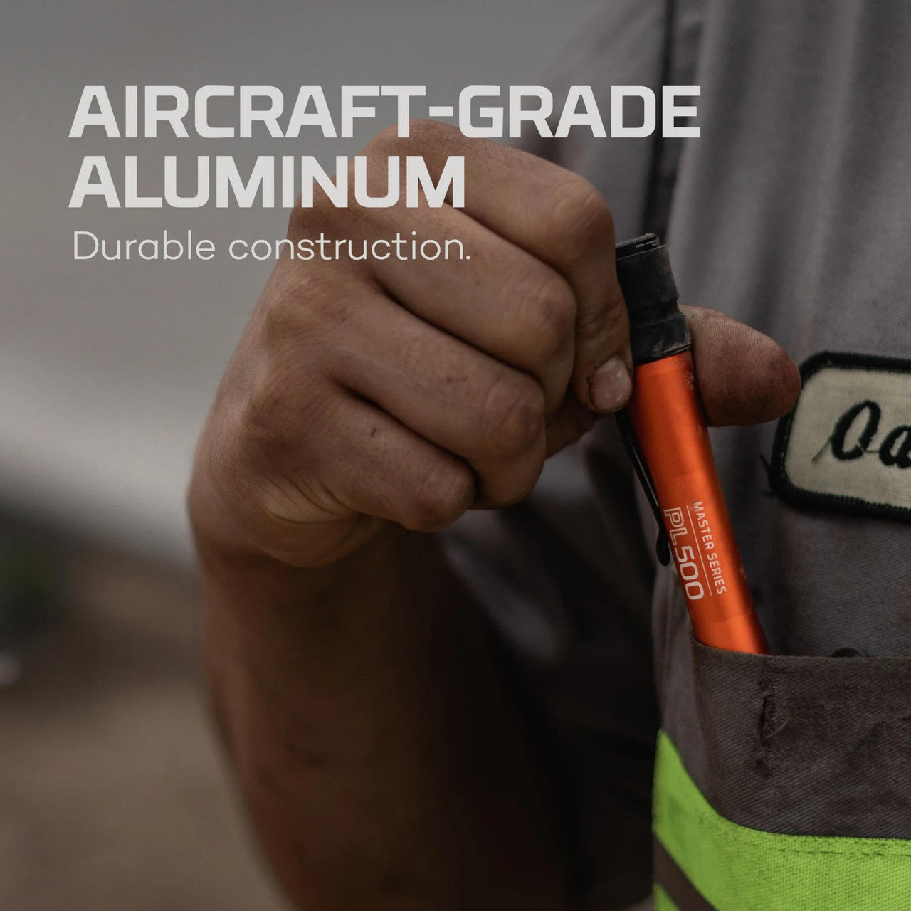 Orange and black handheld tool, likely a screwdriver or similar implement.