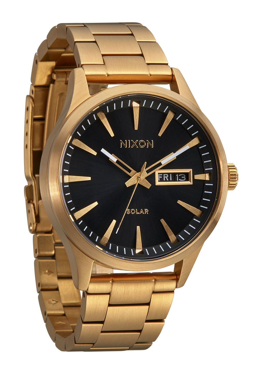 Gold-toned wristwatch with a black dial face displaying the Nixon brand name.