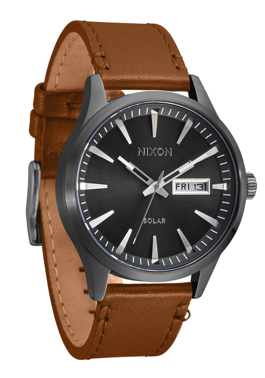 Wristwatch with a black dial, brown leather strap, and day-date display.