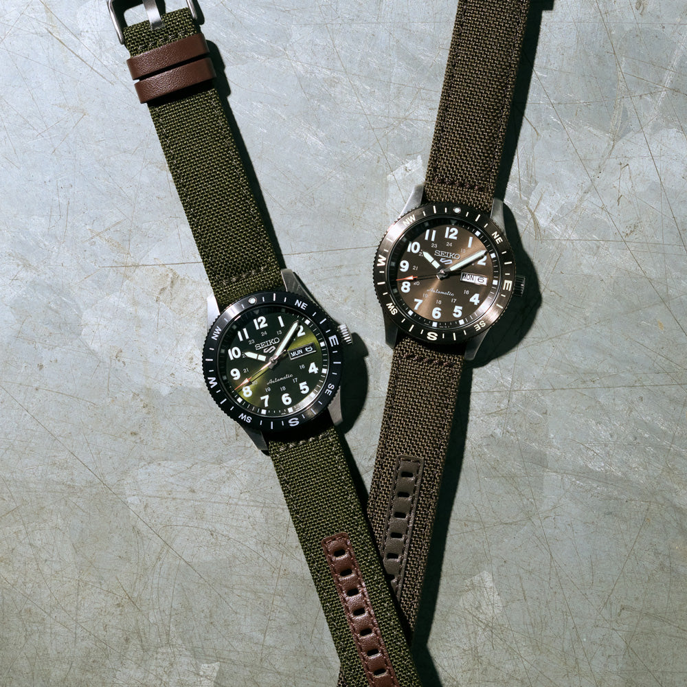 Profile view of the Seiko HDB008K case on its green nylon and leather strap.