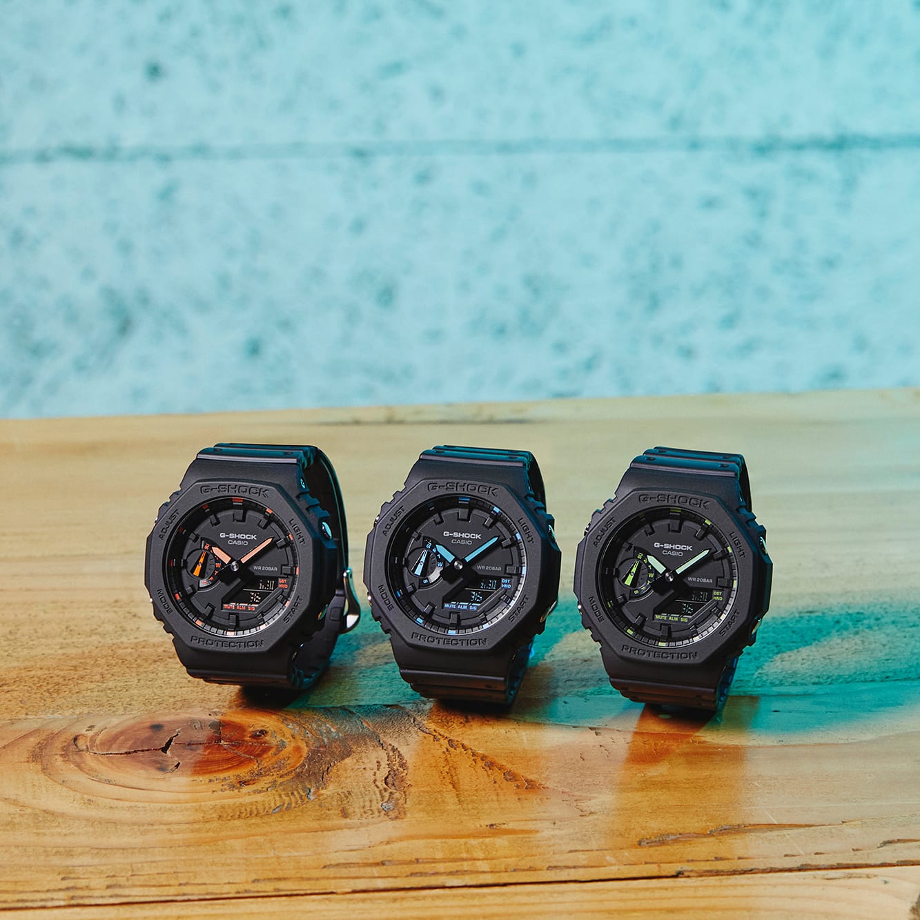 Three black sports watches with round faces displayed side by side.