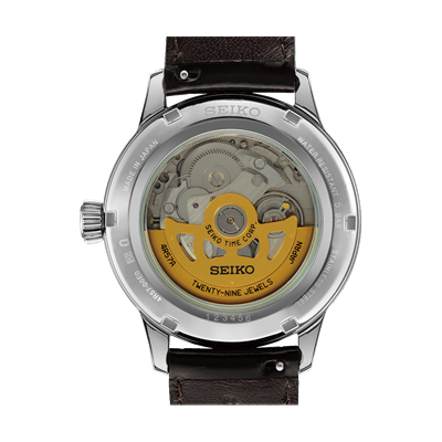 Back of a Seiko automatic watch showing its mechanical movement through a transparent case back.