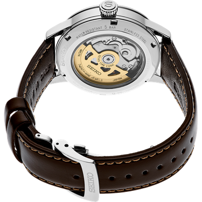 Luxury wristwatch with an exposed mechanical movement visible through the transparent case back.