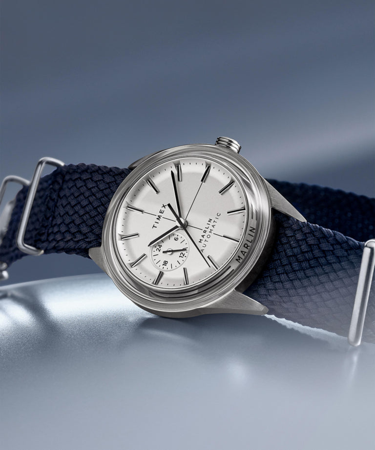 Timex Marlin® Jet Automatic 38mm Fabric Strap Watch TW2V72300 with silver dial and navy strap on display.