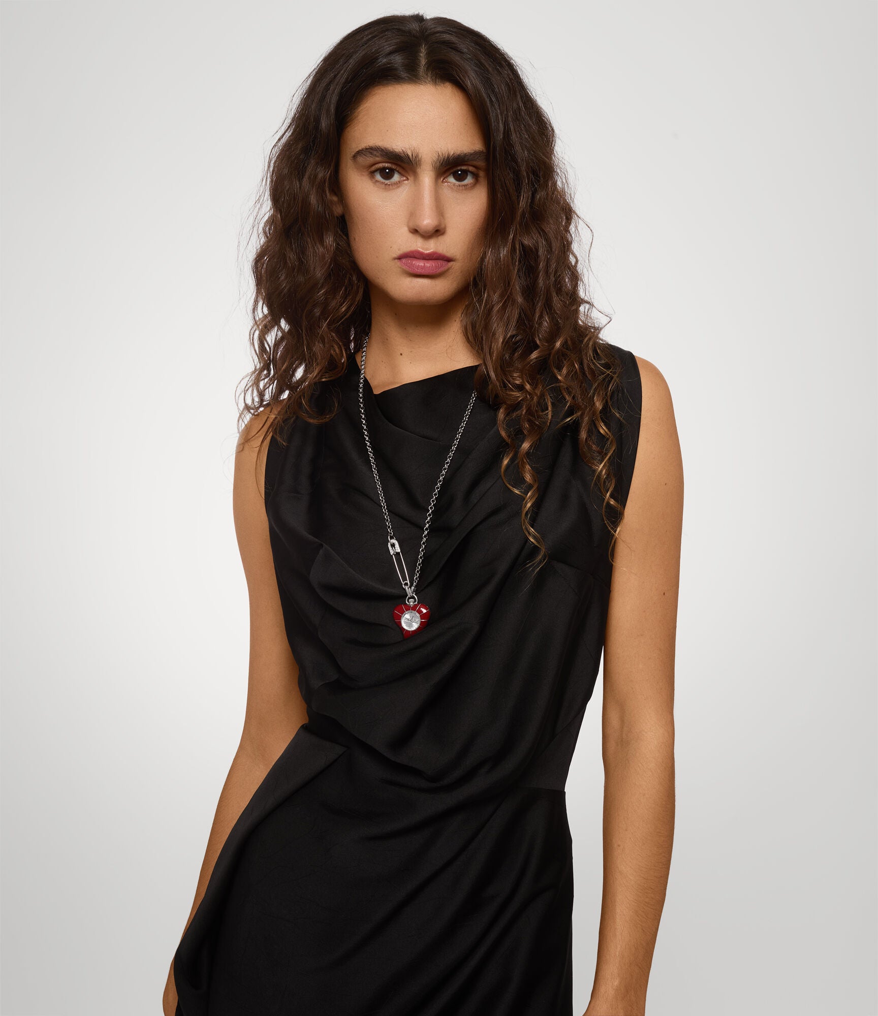 Vivienne Westwood Heart Pendant women's watch with a silver dial and silver pendant chain. Shown at an angle.