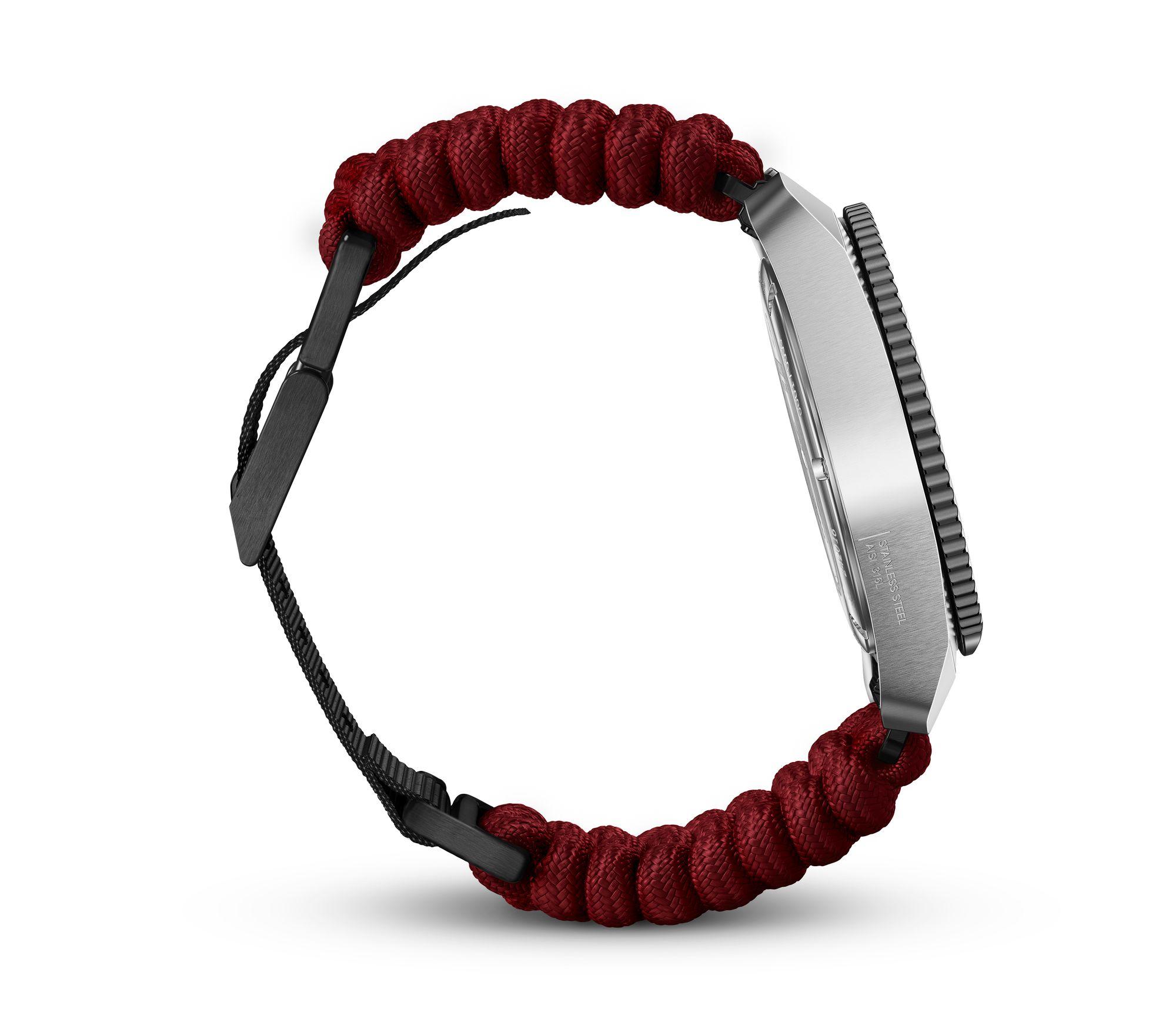 Wristwatch with a red braided fabric strap and silver circular face.