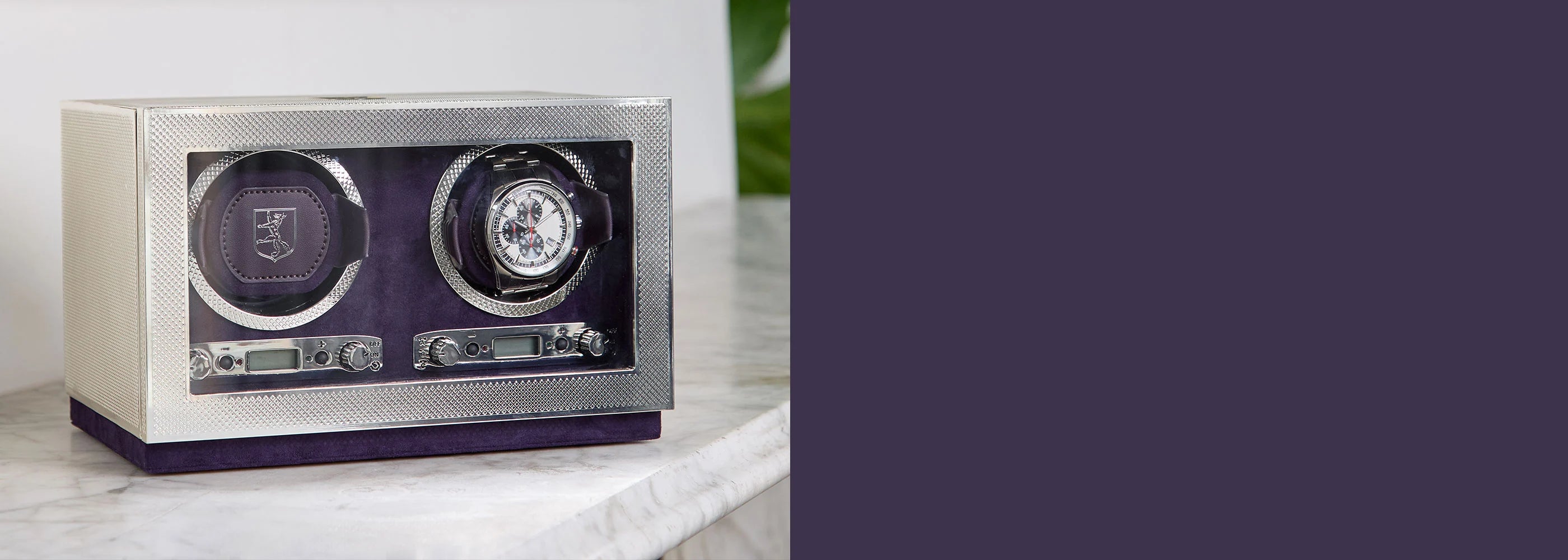 Wristwatch winder with two compartments on a marble surface