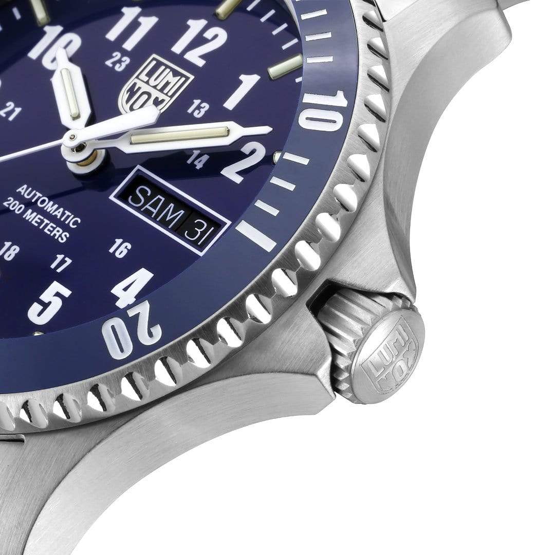 Luxury wristwatch with a blue dial and silver metal case.