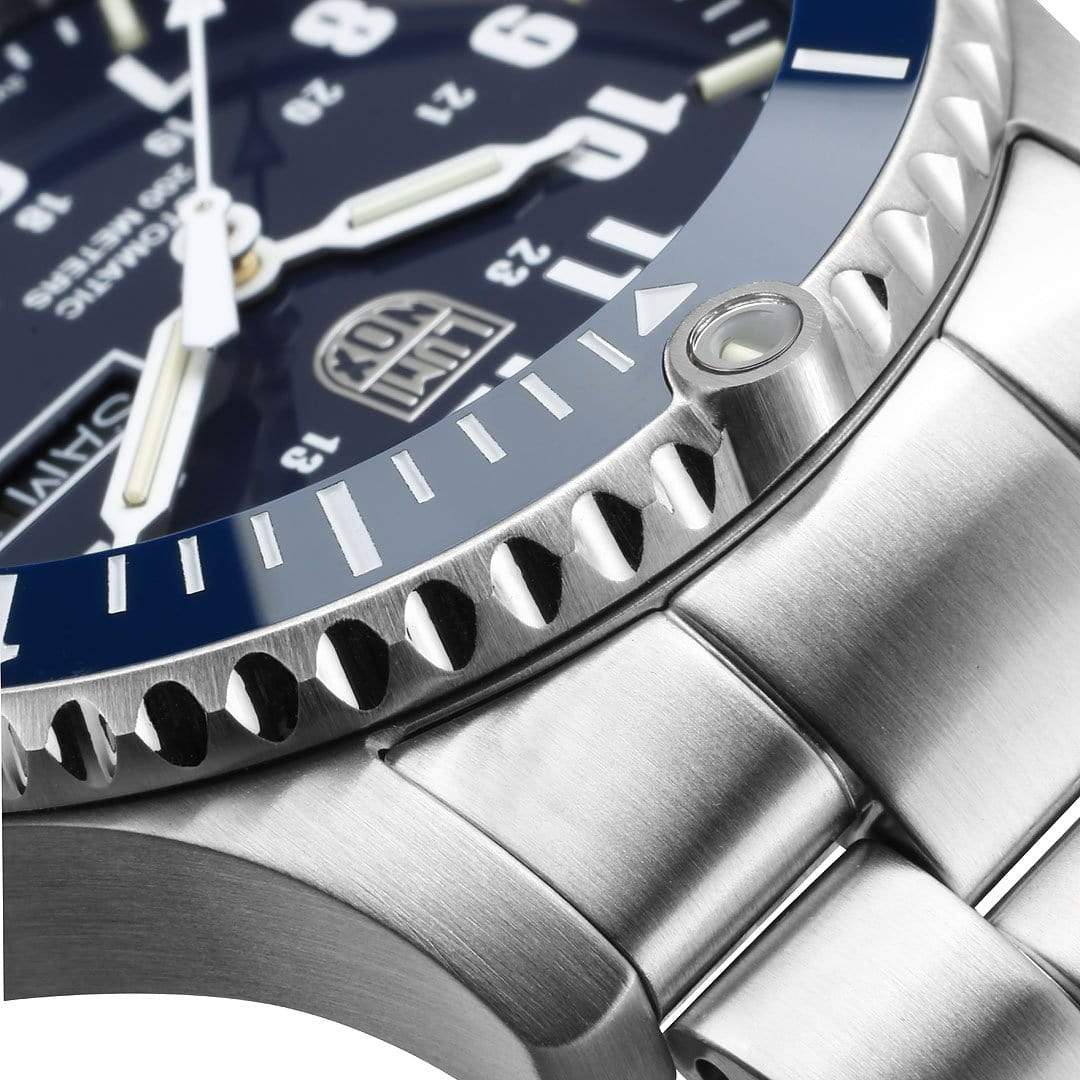 Luxury wristwatch with a blue dial and metal bracelet.