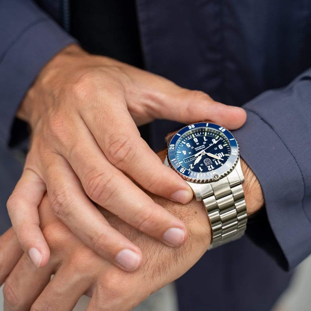 Luxury wristwatch with a blue dial and stainless steel bracelet.