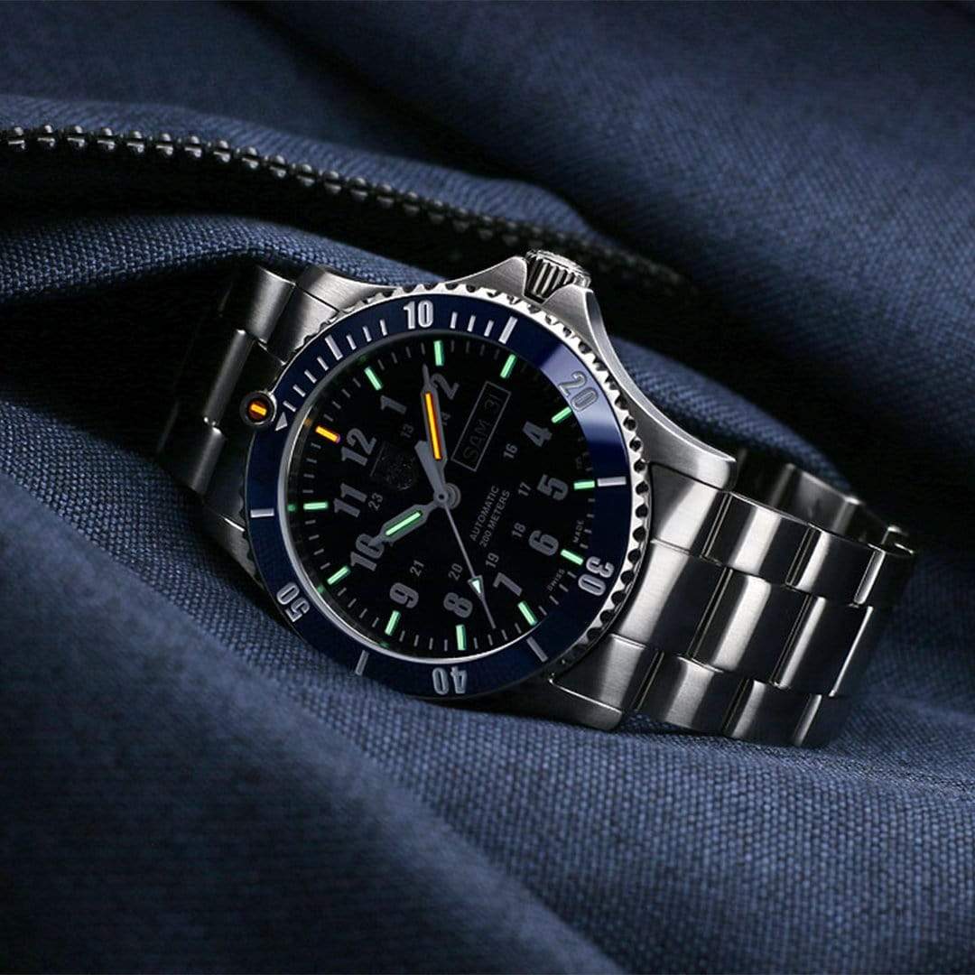 Stainless steel dive watch with a dark blue bezel and black dial.