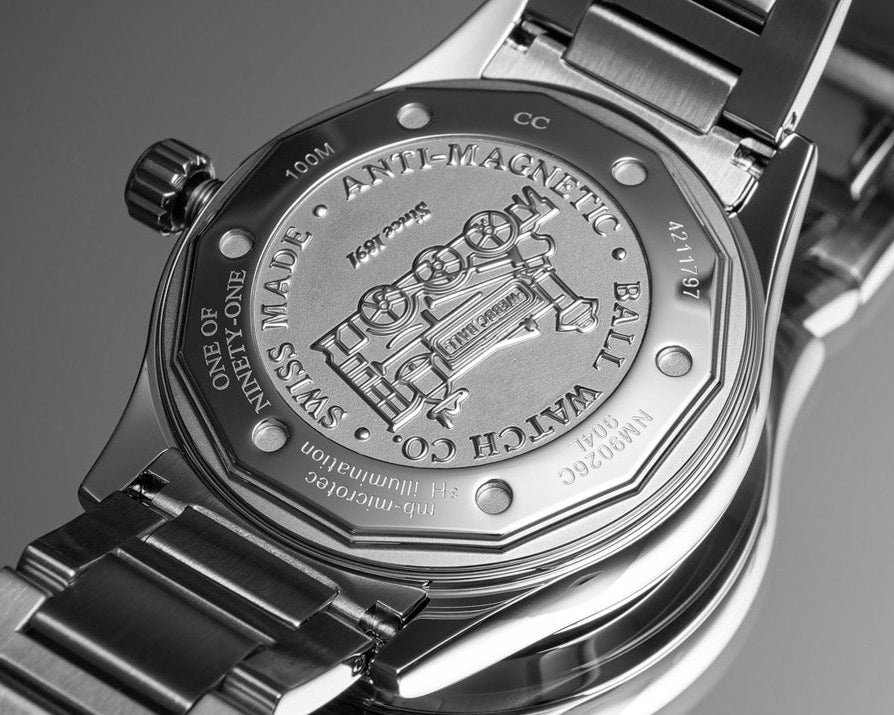 Close-up of a Ball watch with brand engraving on a gray background