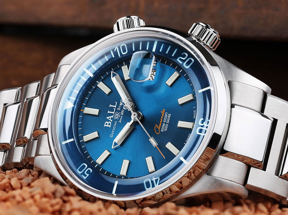 Luxury wristwatch with a blue dial and stainless steel bracelet.