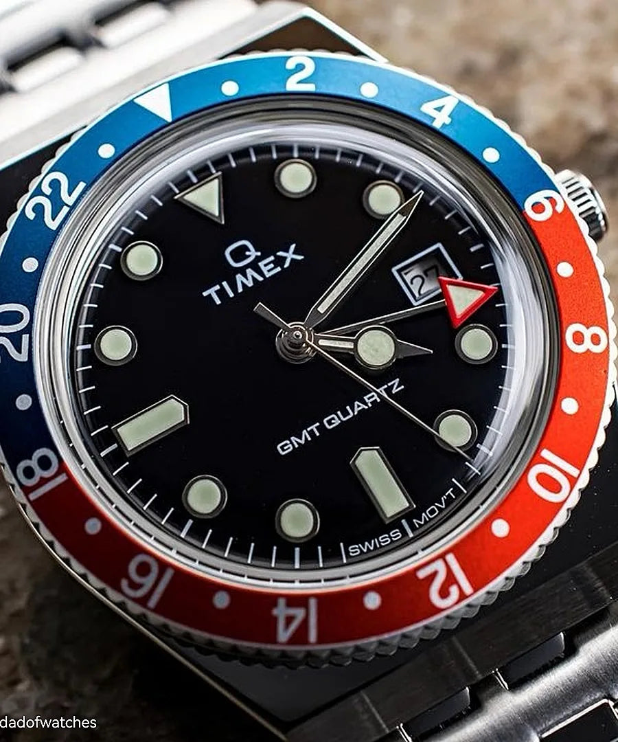 Timex wristwatch with a blue and red bezel and black dial face.