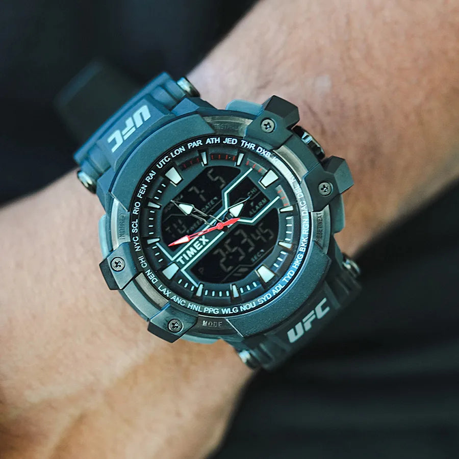 Rugged teal digital sports watch with a complex dial and UFC branding worn on a wrist.