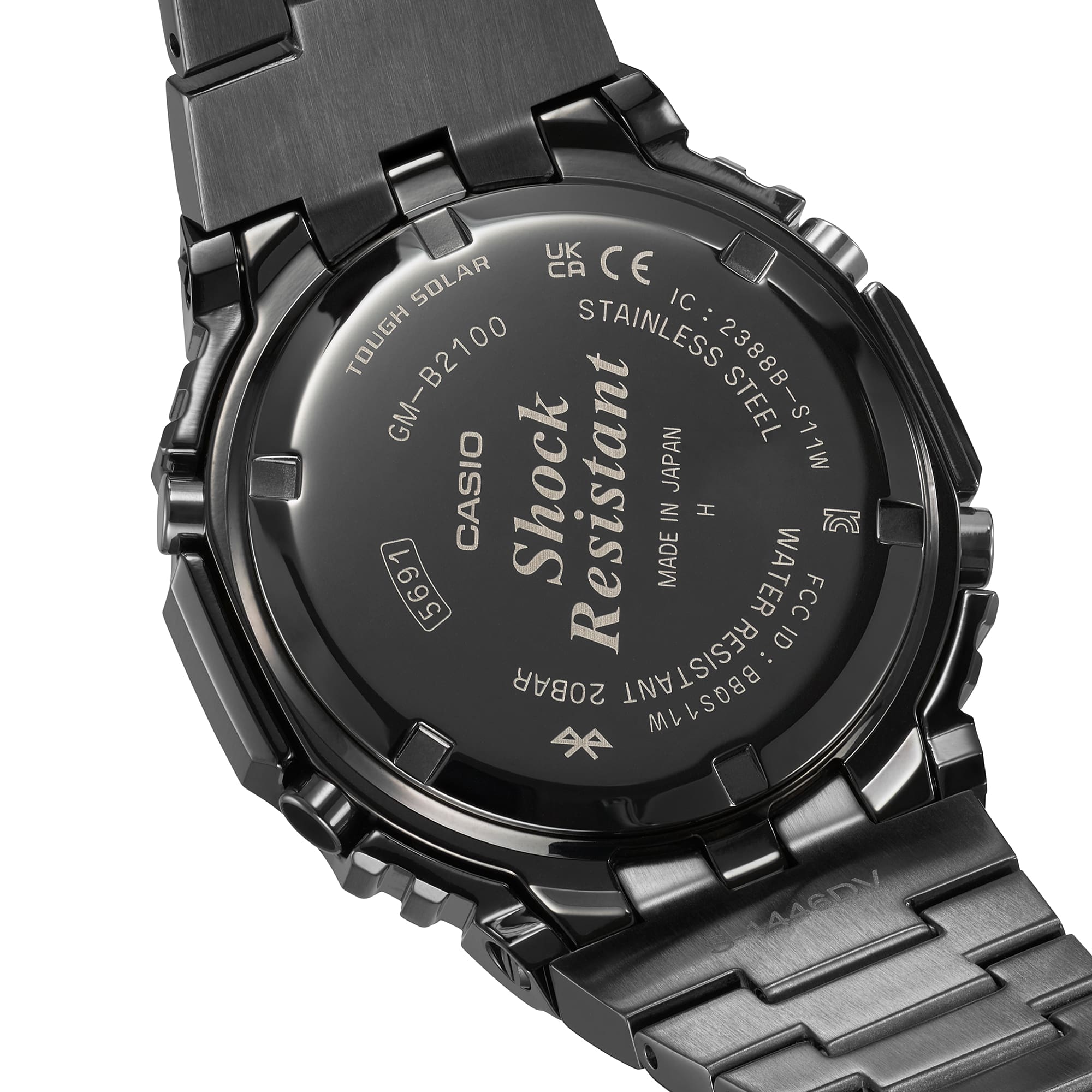 Back of a black stainless steel wristwatch with engraved text.