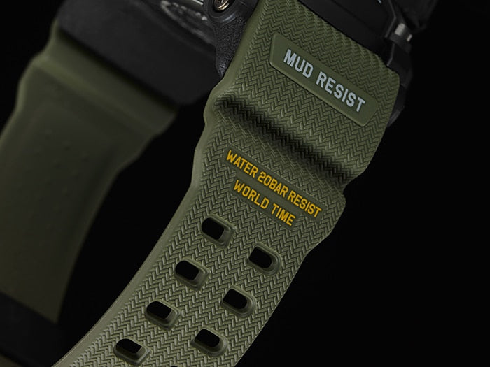 Green fabric watch strap with ’MUD RESIST’ and ’WATER 200M RESIST’ text visible.