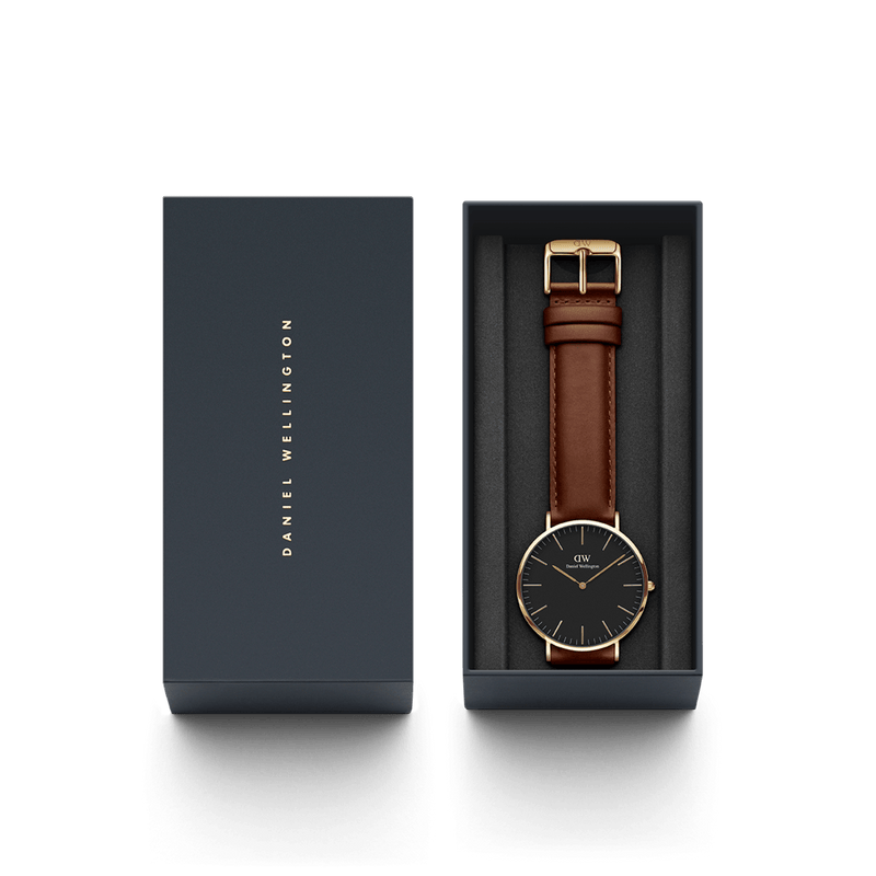 Elegant wristwatch with a brown leather strap and black face in a gift box.