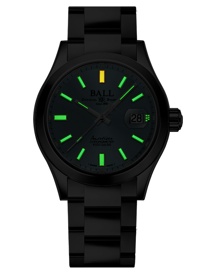Black wristwatch with luminous green hour markers and a single yellow marker.
