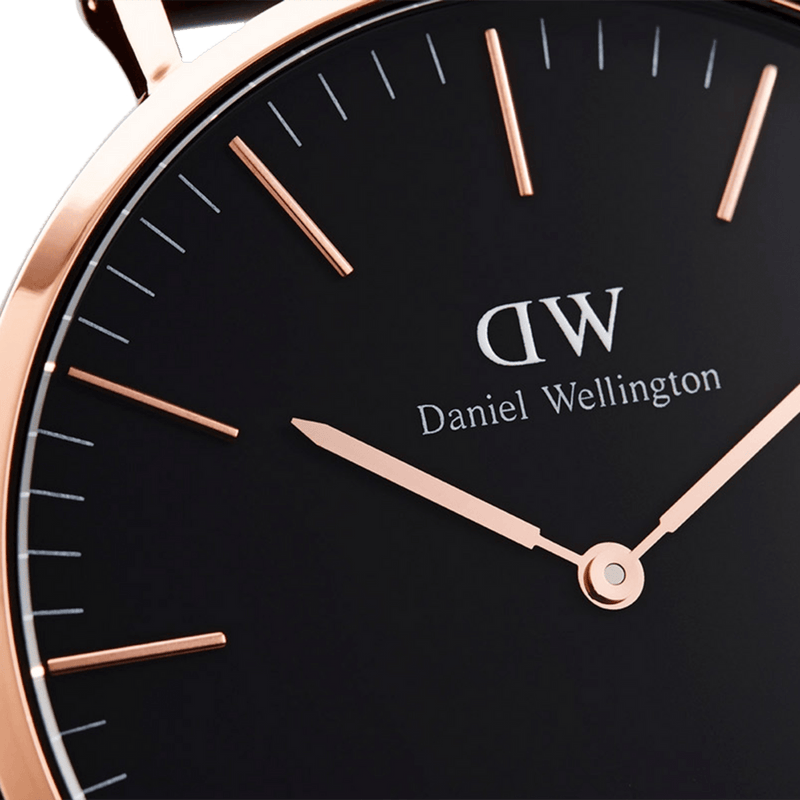 Elegant wristwatch with a black face and rose gold accents, displaying the Daniel Wellington brand.