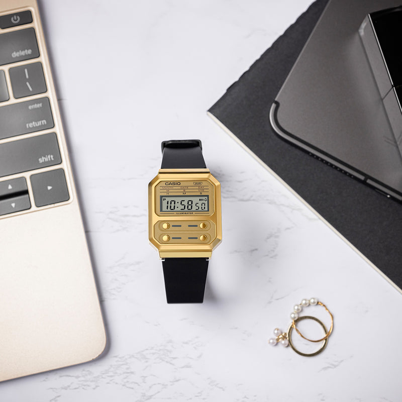 Gold-colored digital watch with a black strap and rectangular face displaying the time.