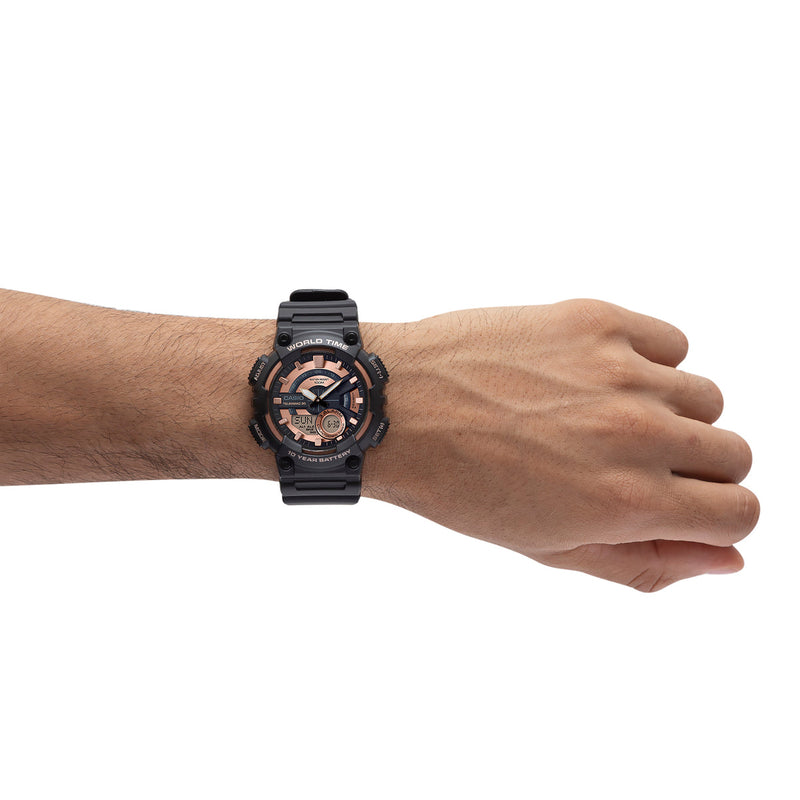 Black and rose gold sports watch worn on a wrist.