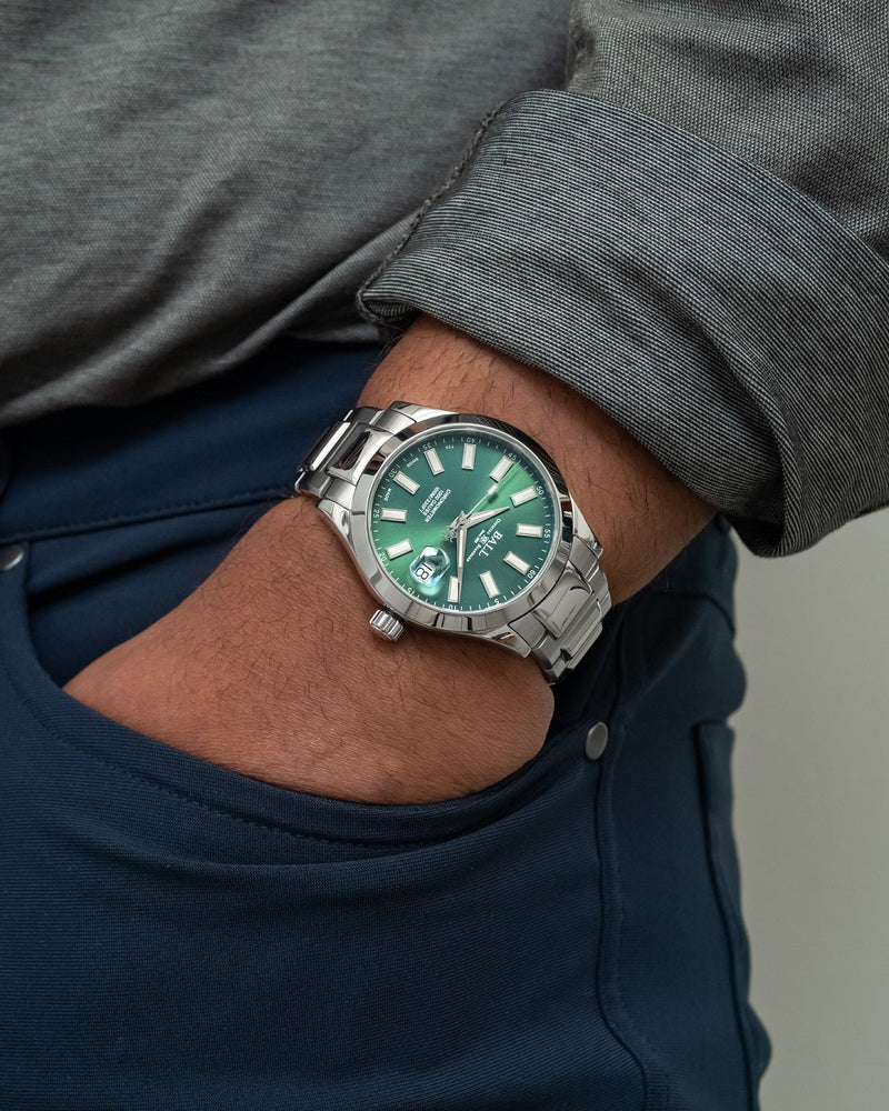 Stainless steel wristwatch with a green dial and silver bracelet.