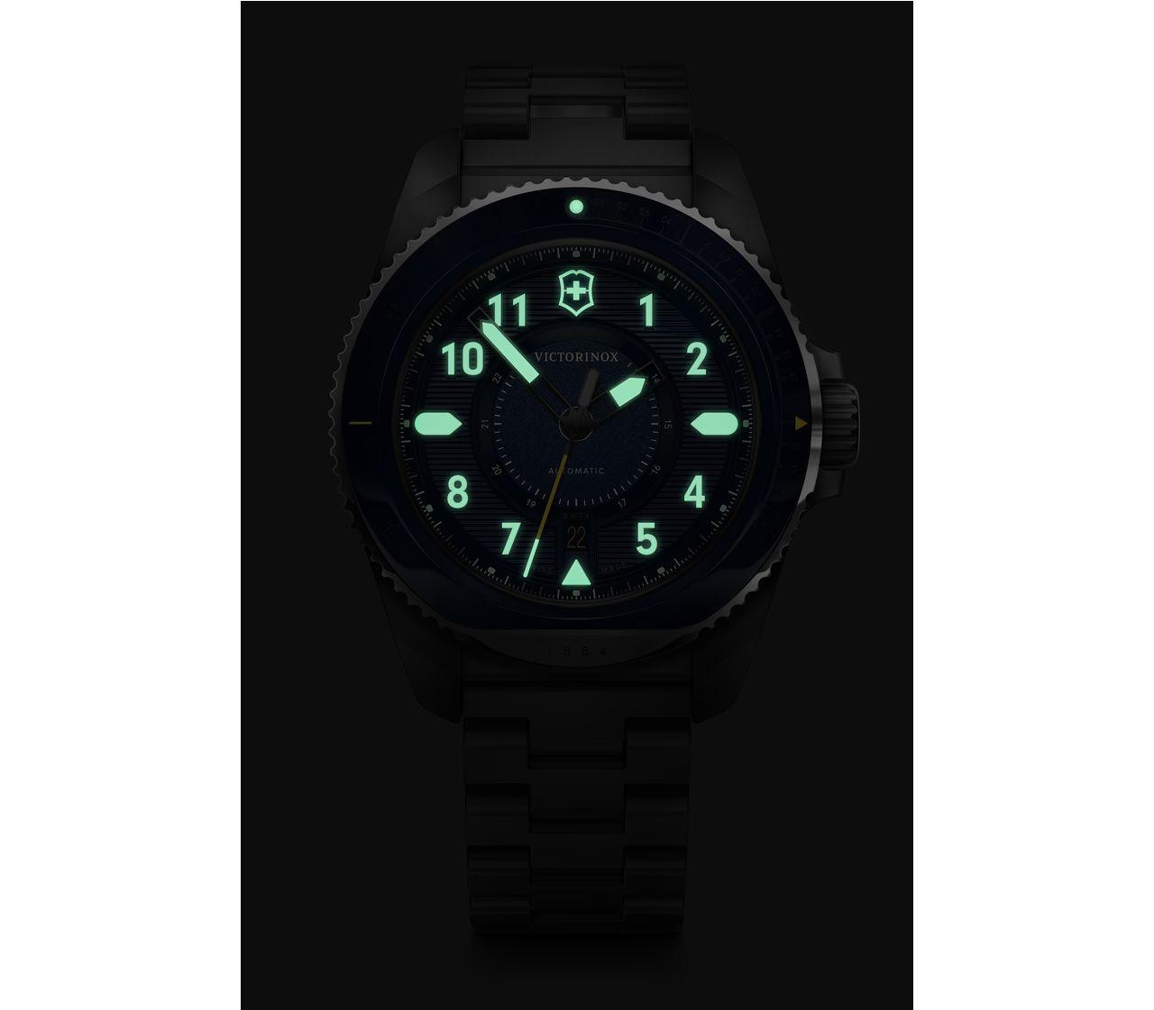 Luminous analog watch face displaying 11:30 in a dark setting.