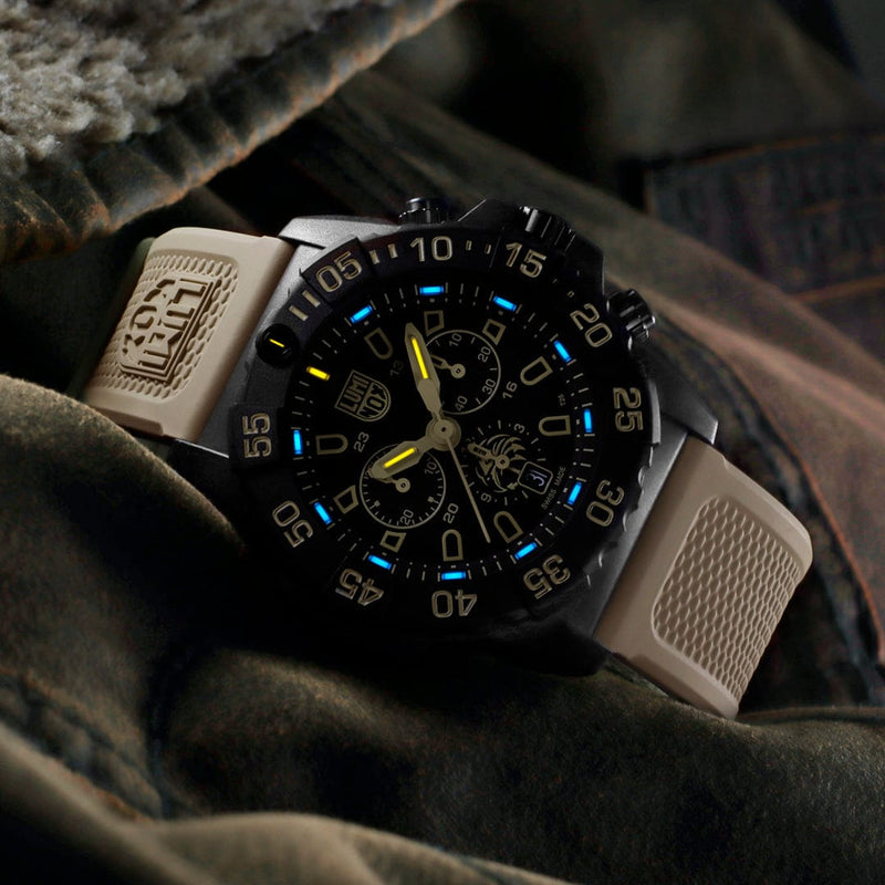 Rugged tactical wristwatch with a black face and tan strap.