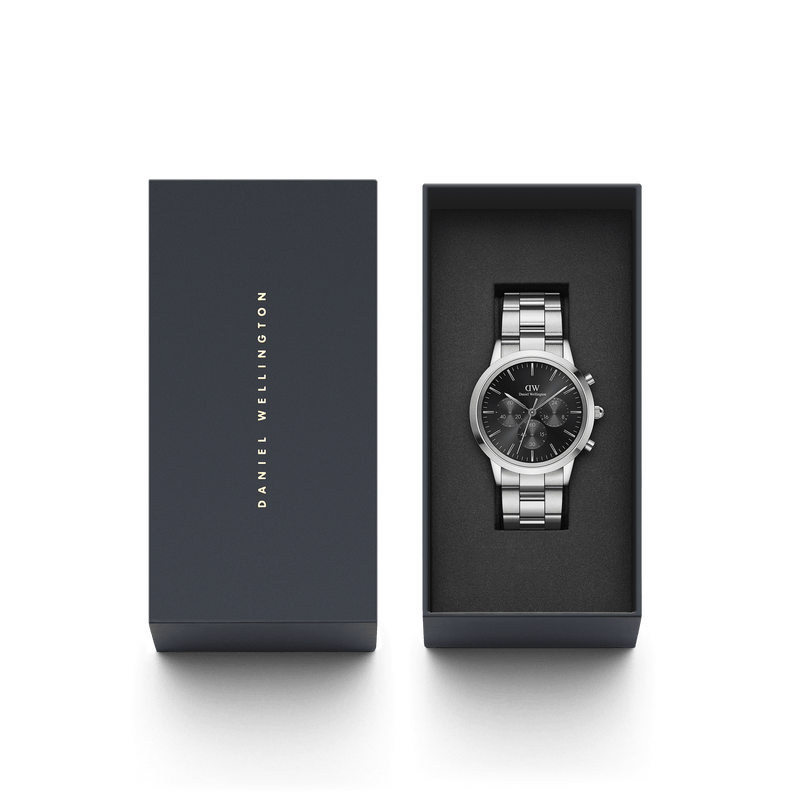 Stainless steel chronograph wristwatch with a dark face in an open gift box.