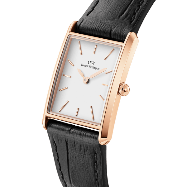 Elegant rectangular wristwatch with a rose gold case, white dial, and black leather strap.