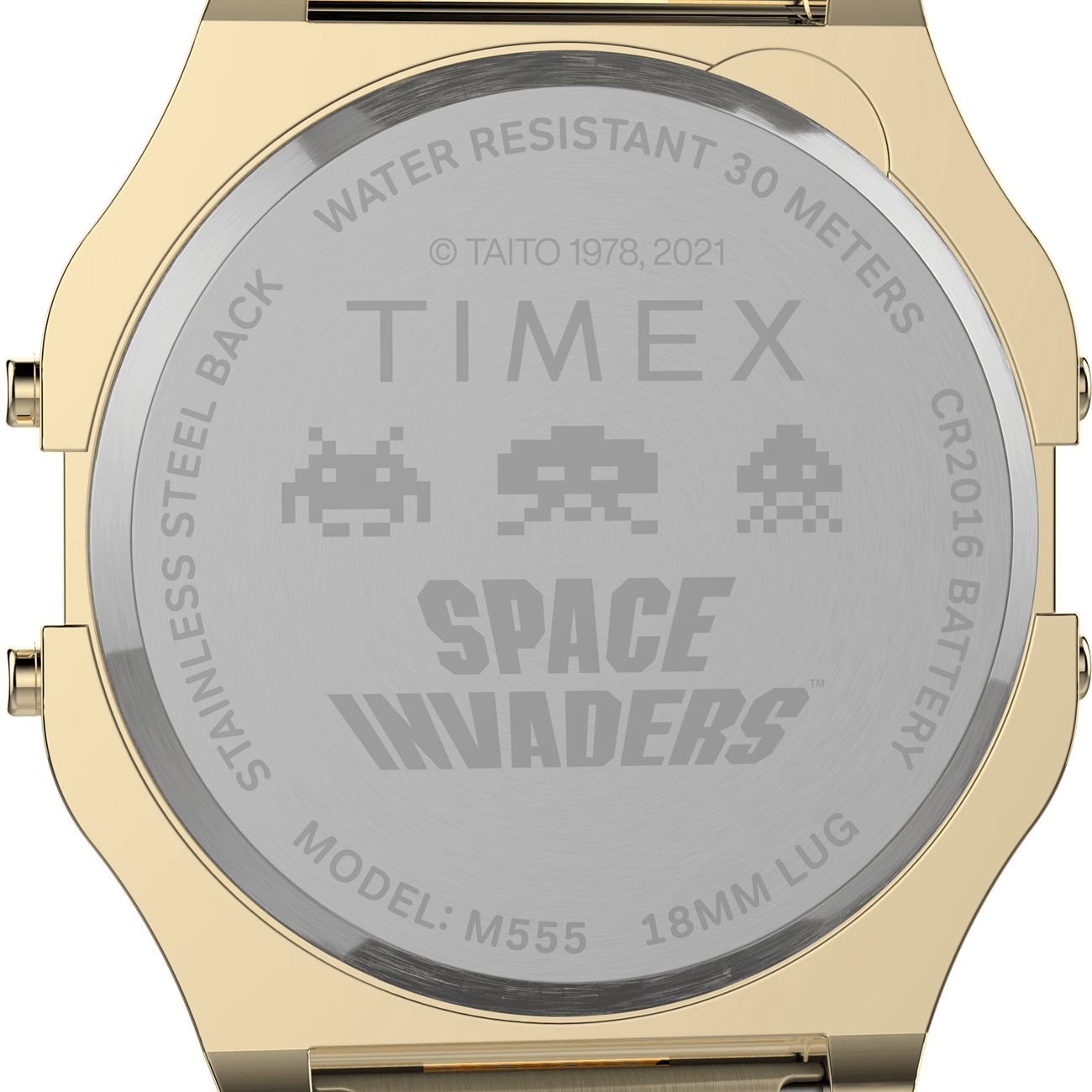Back of a gold-toned Timex watch featuring a Space Invaders design engraving.