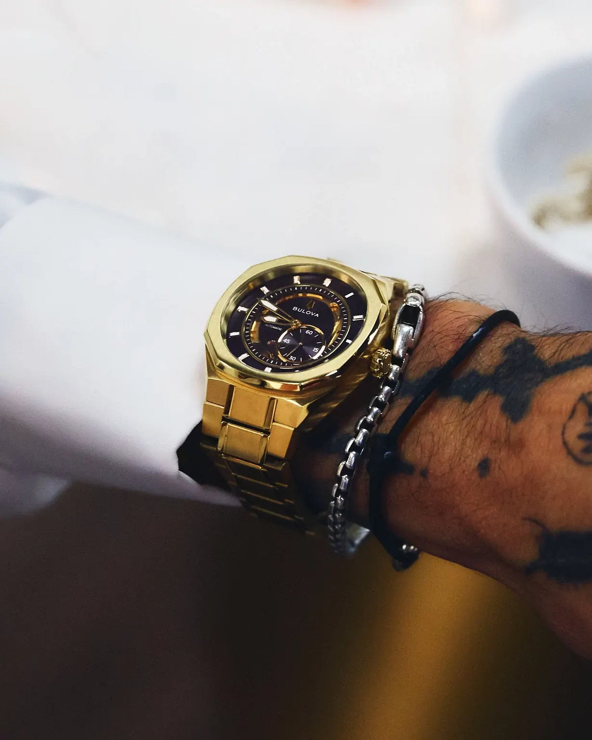 Bulova Marc Anthony Surveyor 97A204 automatic men's watch with black sunray dial and gold-tone stainless steel bracelet — caseback view