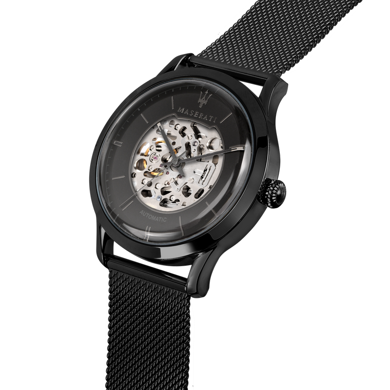 Black wristwatch with a visible skeleton mechanism and mesh metal band.