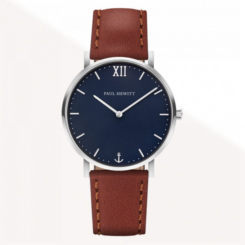 Wristwatch with a navy blue face, silver case, and brown leather strap.