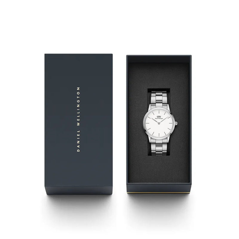 Elegant silver wristwatch with a white face displayed in a dark presentation box.