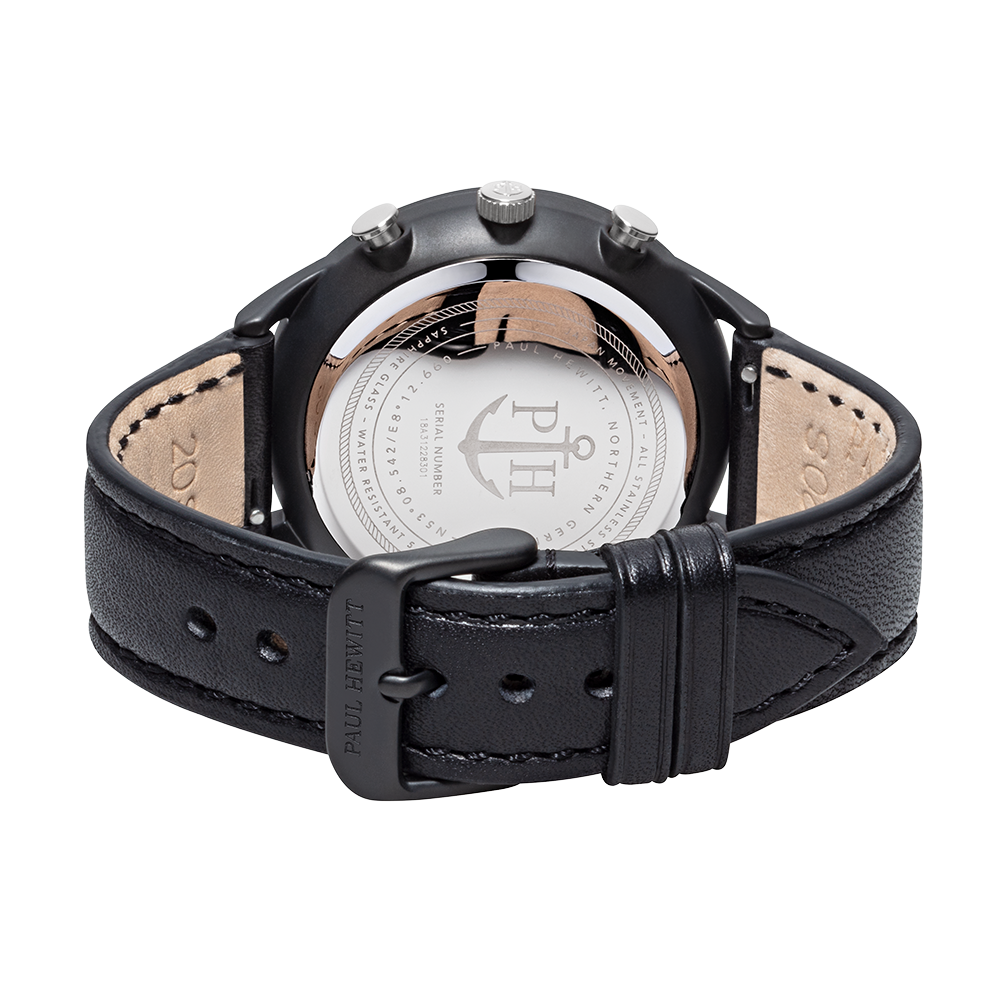 Black leather wristwatch with a visible caseback displaying an anchor logo.