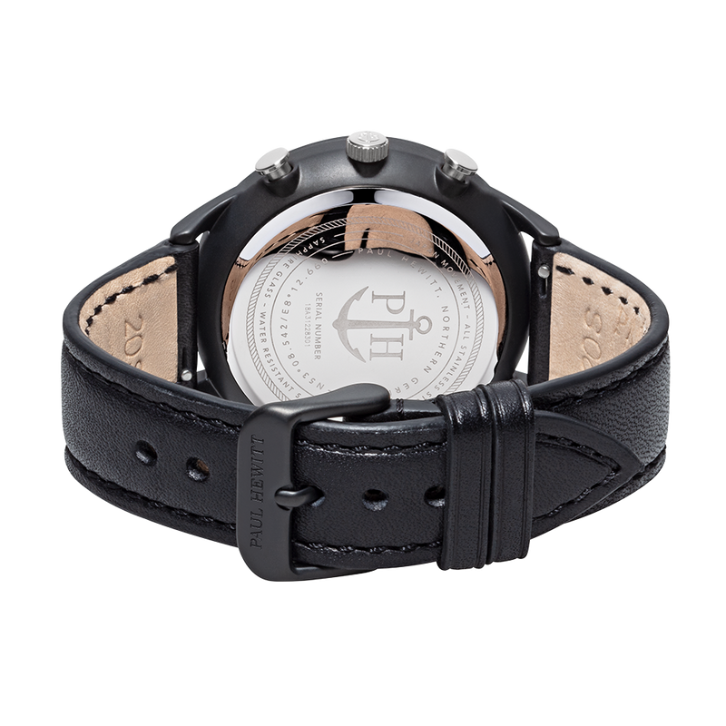 Black leather wristwatch with a visible caseback displaying an anchor logo.