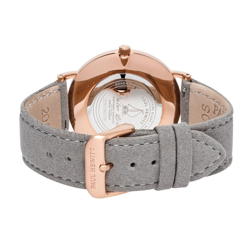 Wristwatch with a rose gold case and gray suede leather strap.