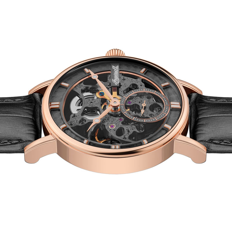 Luxury skeleton watch with a rose gold case and black leather strap.