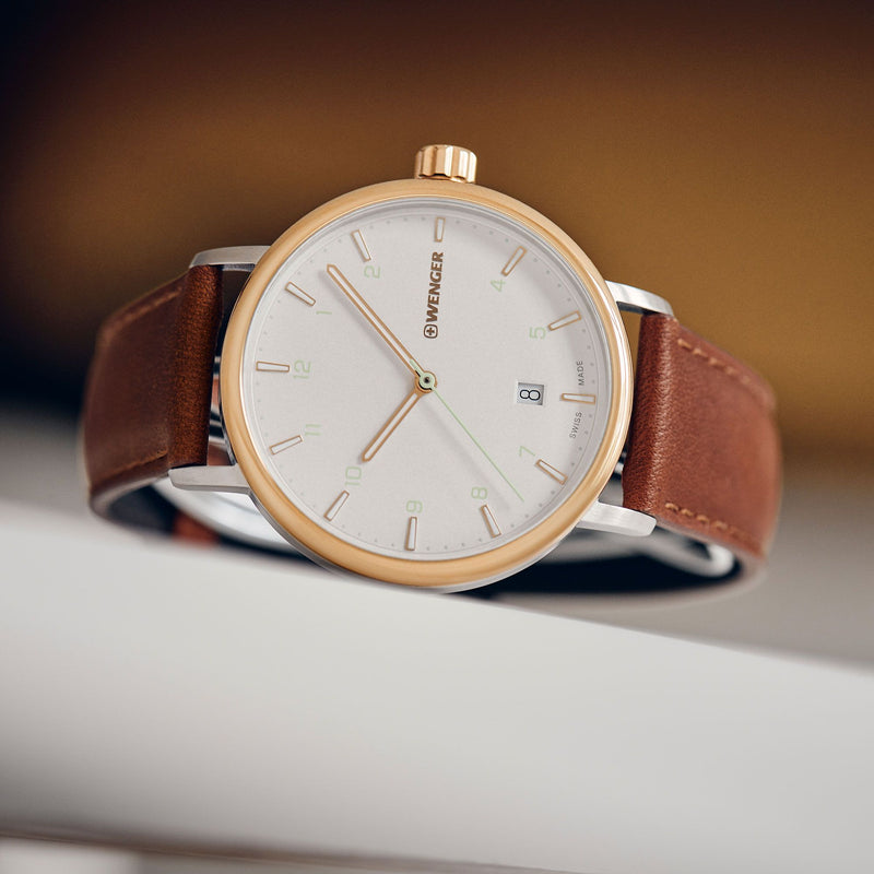 Elegant wristwatch with a brown leather strap and gold-toned case.