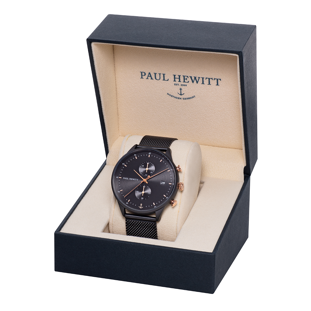 Black wristwatch with a mesh band displayed in an open presentation box.