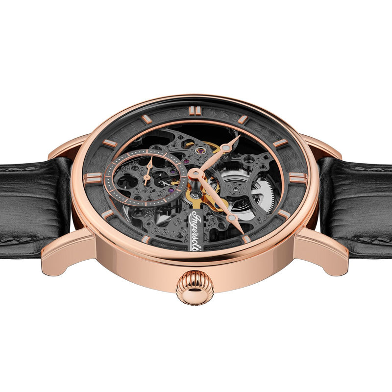 Luxury skeleton watch with a rose gold case and black leather strap.