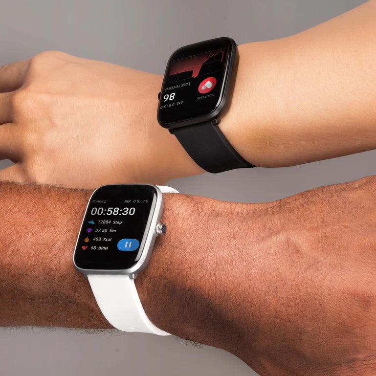 Two smartwatches worn on wrists, one with a black band and one with a white band.