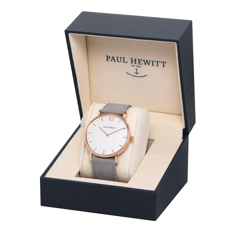 Elegant wristwatch with a rose gold case and gray leather strap in a branded presentation box.