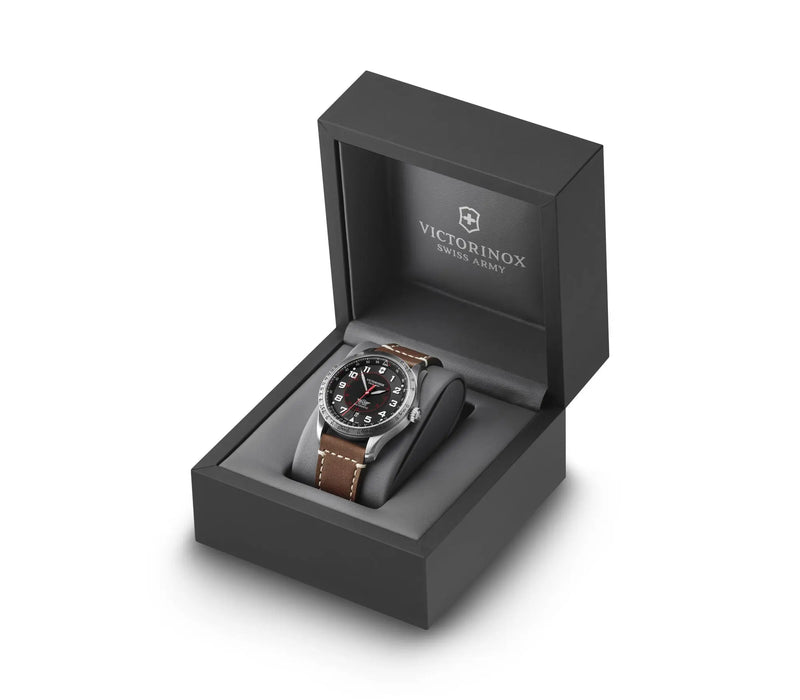 Wristwatch with a brown leather strap in a black presentation box.