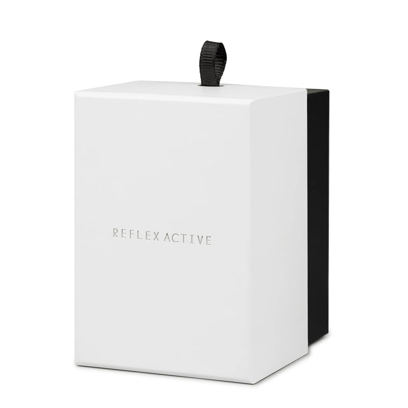 White cube-shaped box with ’REFLEX ACTIVE’ embossed on the front and a black top handle.