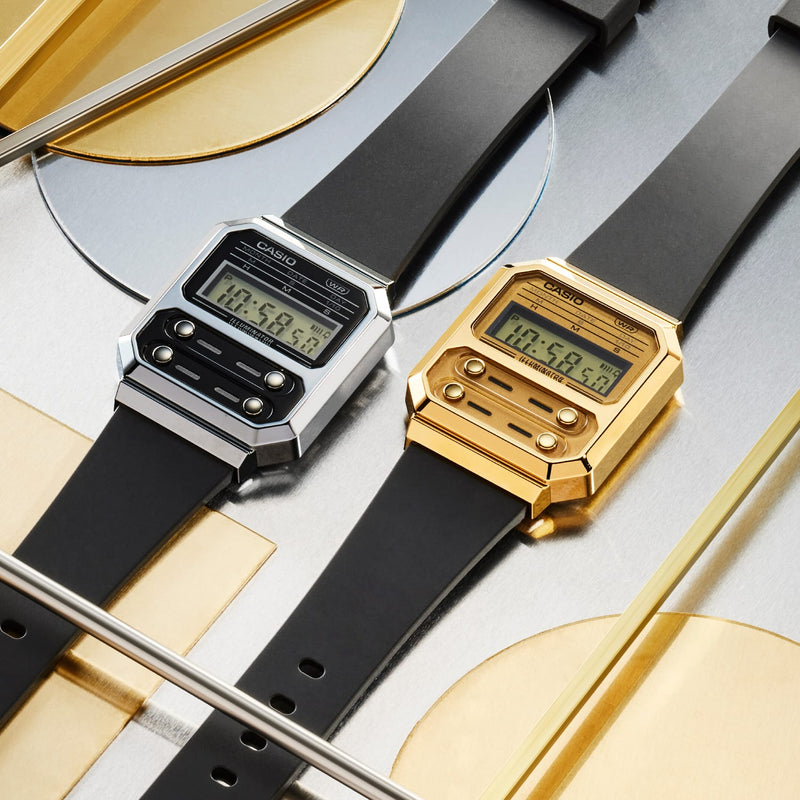 Two digital wristwatches with square faces, one silver and one gold-colored, displayed side by side.