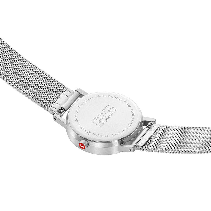 Stainless steel wristwatch with a mesh band and engraved case back.