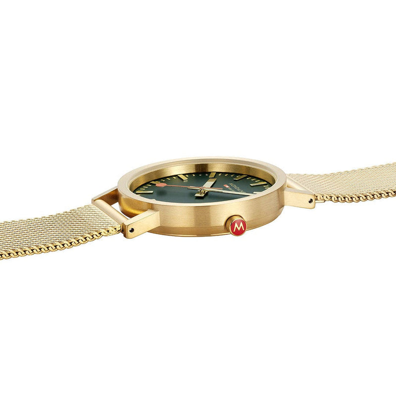 Gold wristwatch with a green dial and mesh band.